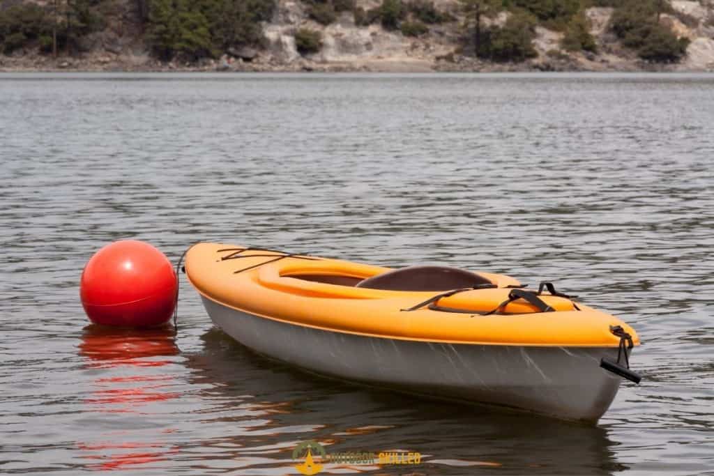 an anchored kayak to show How To Anchor A Kayak without a Trolley