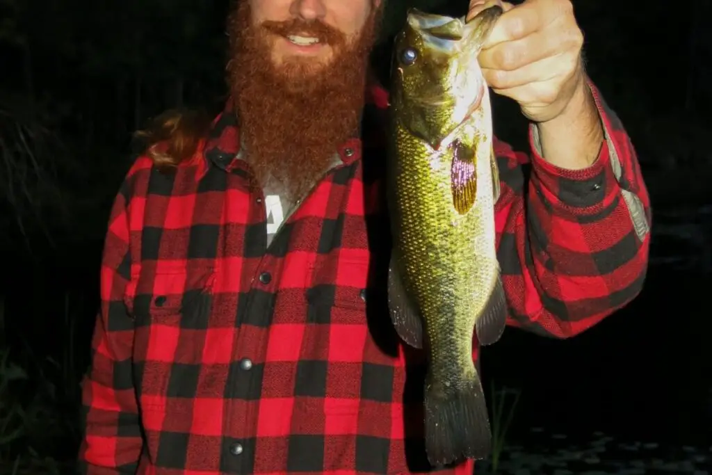 holding bass at night to show how to catch bass at night