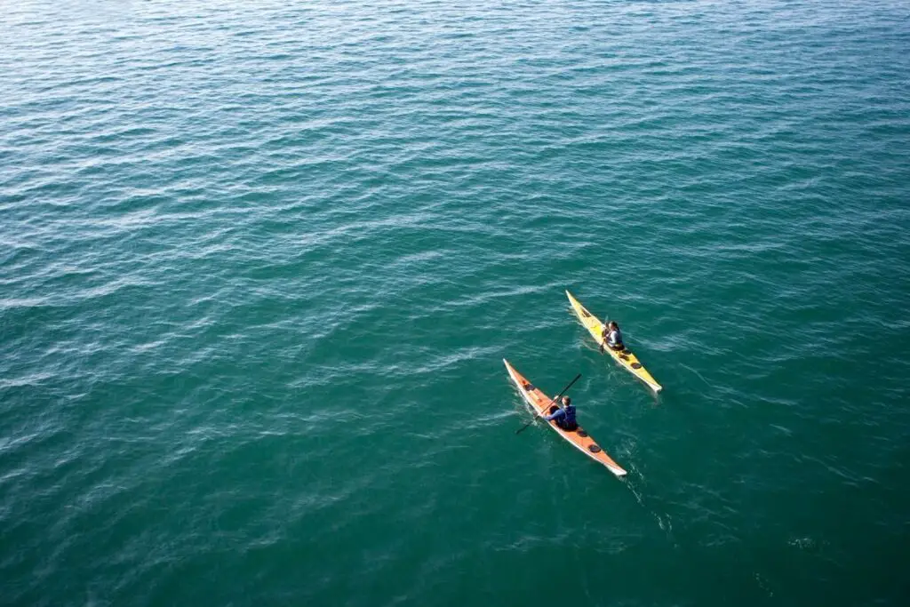 Two kayaks in the sea to show How Far Out to Sea Can You Go in a Kayak