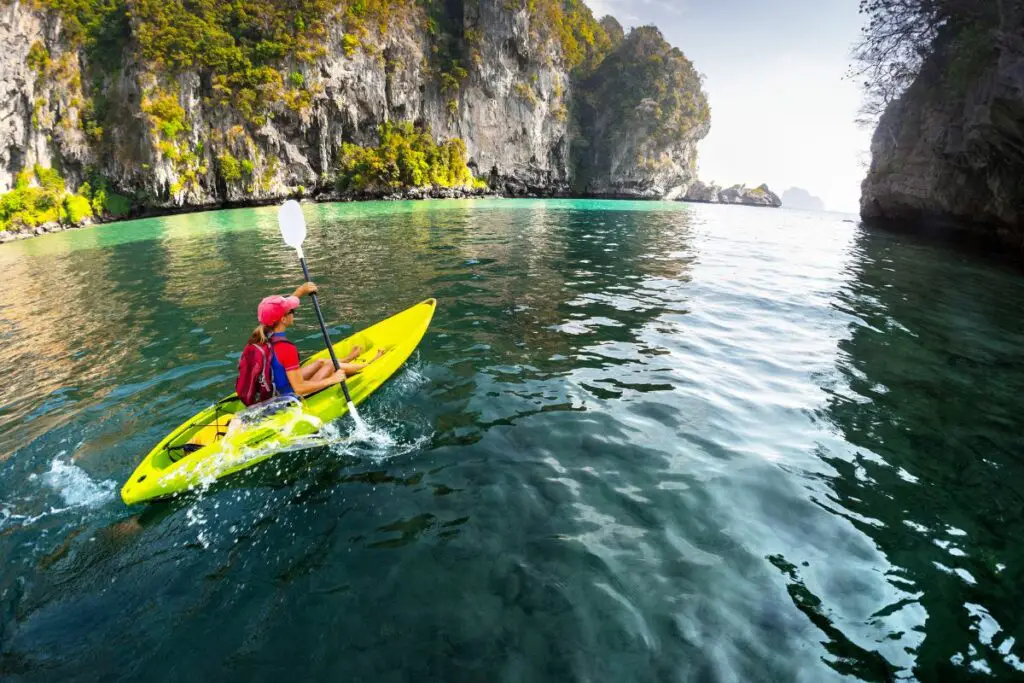 a photo of a woman kayaking to answer do i need a license to kayak in singapore