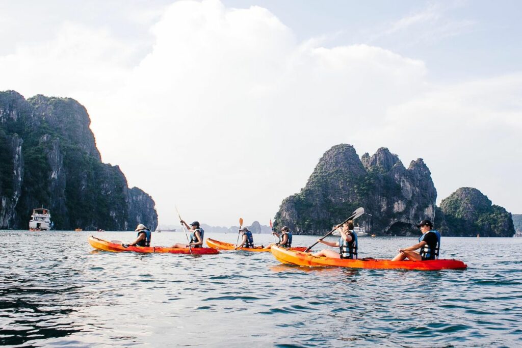 a photo of a group of kayakers to answer is kayaking hard for beginners