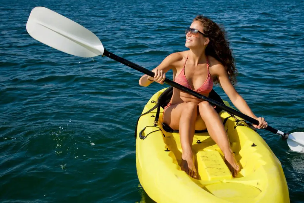 a photo of a fit paddler to show how does kayaking work your legs