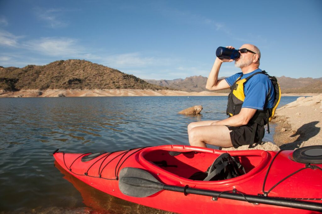 a photo of a kayaker drinking to show can you kayak while drunk
