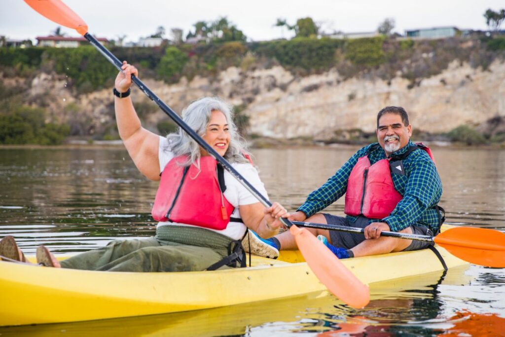 a photo of two overweight kayakers to answer can you kayak when overweight