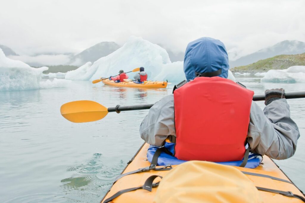 a photo of a kakyer in cold weather to show how to stay warm kayaking