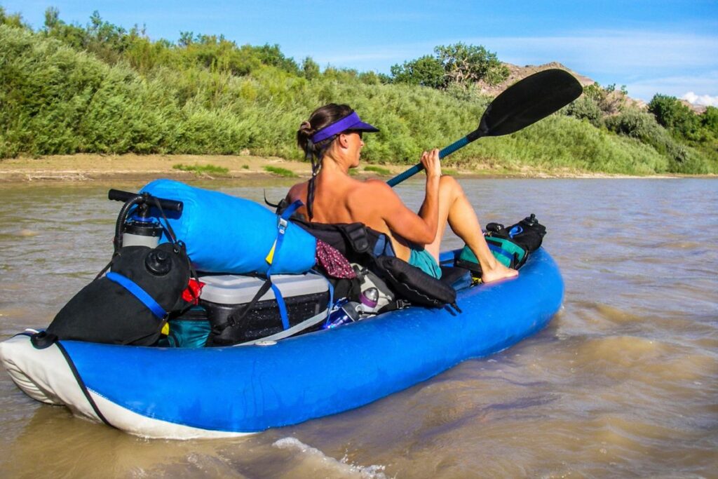 a photo of a kayaker with a packed kayak to show how to increase the weight capacity of a kayak