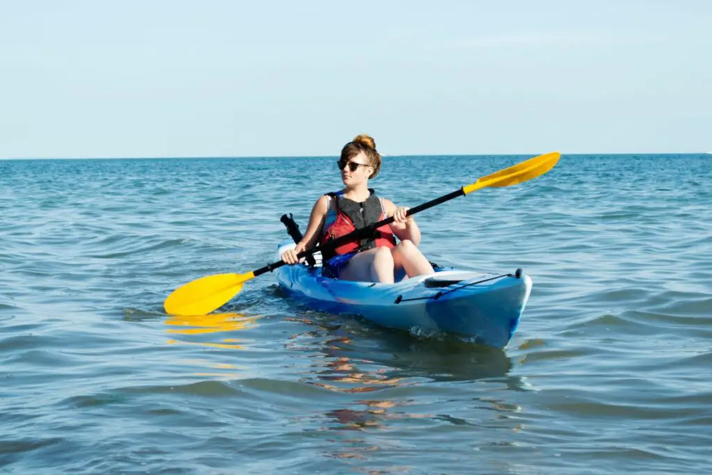 a photo of a kayaker in the sea to show the best time to go sea kayaking